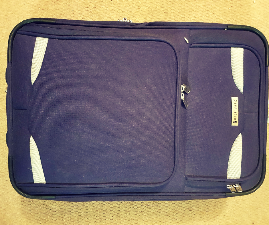 Small Purple Revelation suitcase with silver accents small enough to use as hand luggage for most airlines