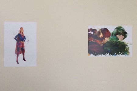 A painting of Supergirl in the classic red and blue costume next to a painting of the Flash in red fighting Green Arrow