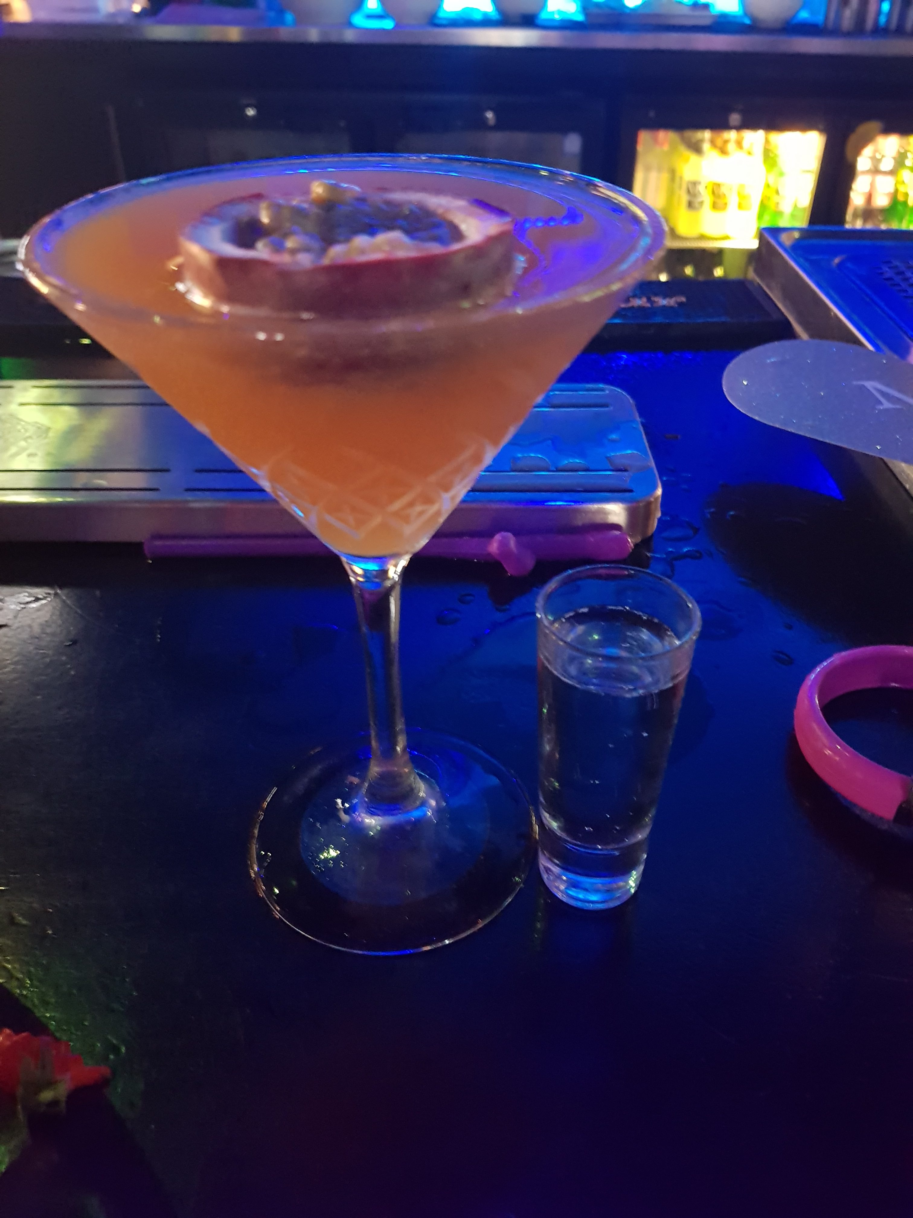 Porn star martini at andwhynot Mansfield. Orange drink served in a martini glass with half a passion fruit and a shot of prosecco
