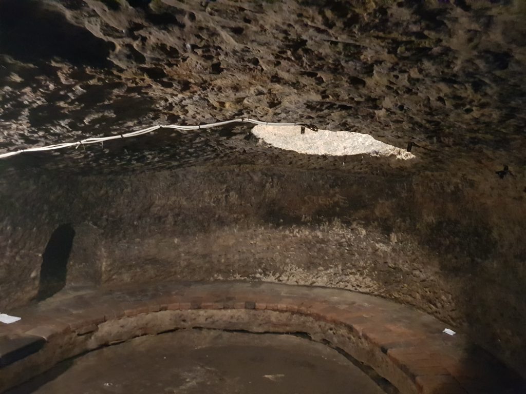 A rounded cave with a hole in the roof. The final stop on the Nottingham Ghost Tour