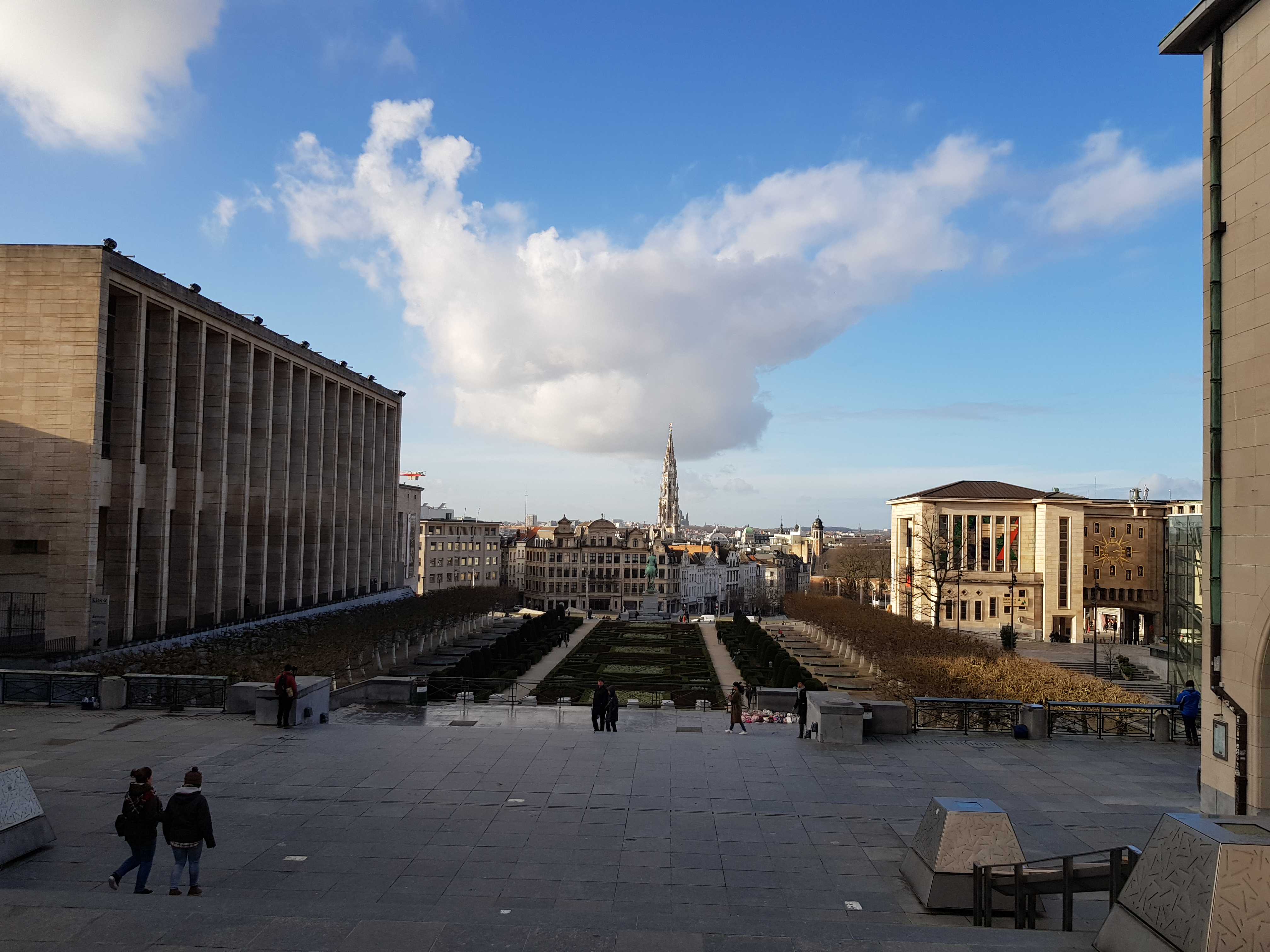 A view of the city of brussels with the library to the left and a stairway with a small garden to the front