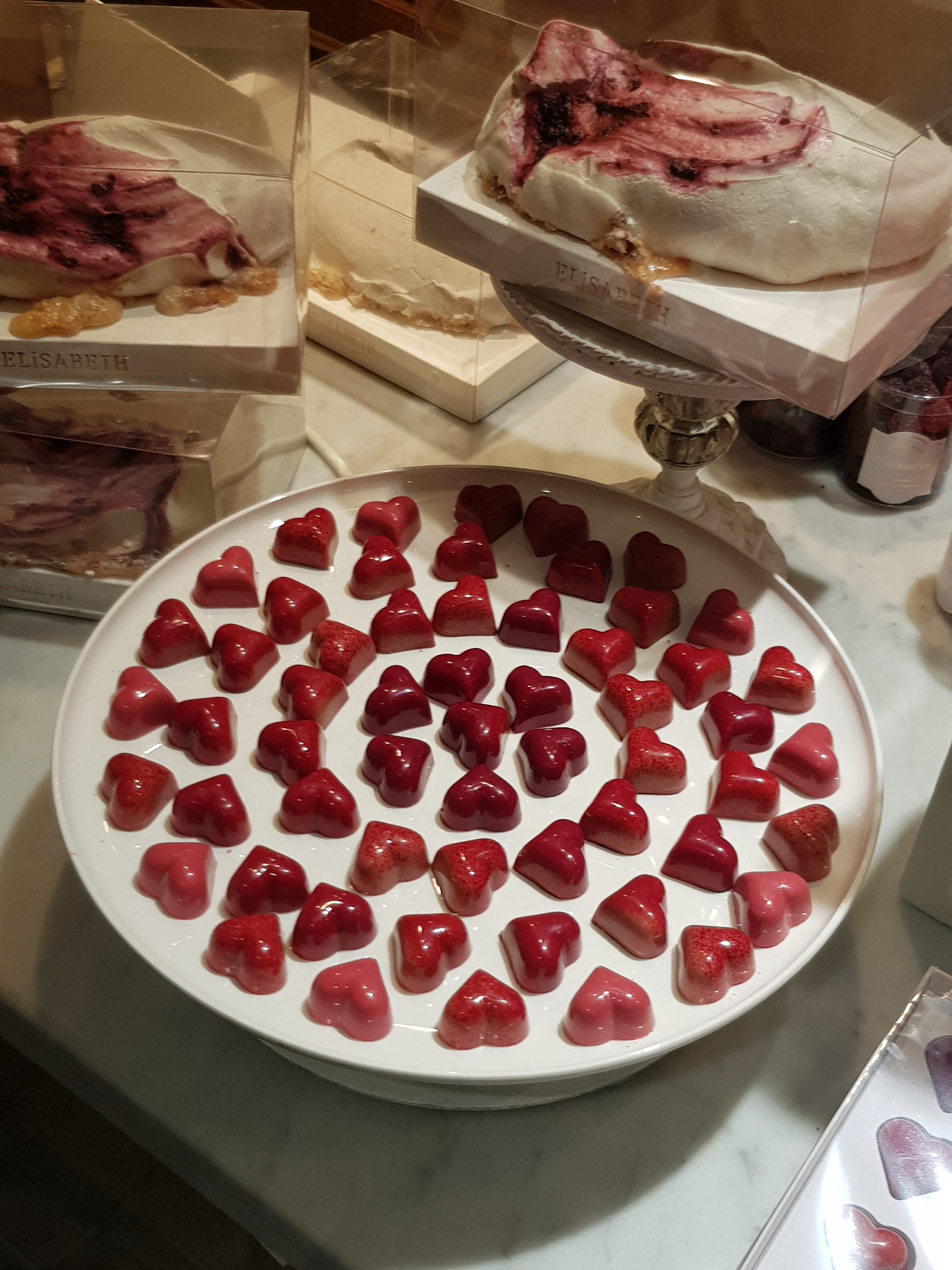 a plate of red heart shaped Belgian Chocolates
