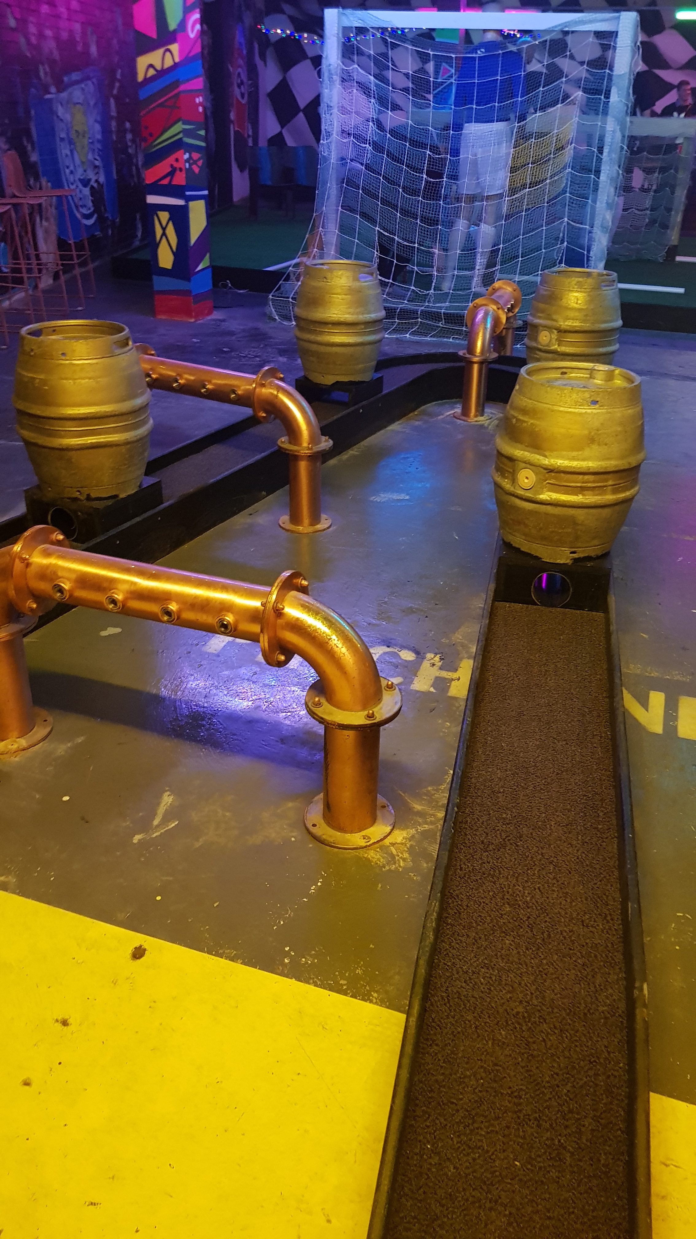 One of the mini golf holes at Caddyshackers. Beer kegs and copper piping make obstacles for the ball to go through 