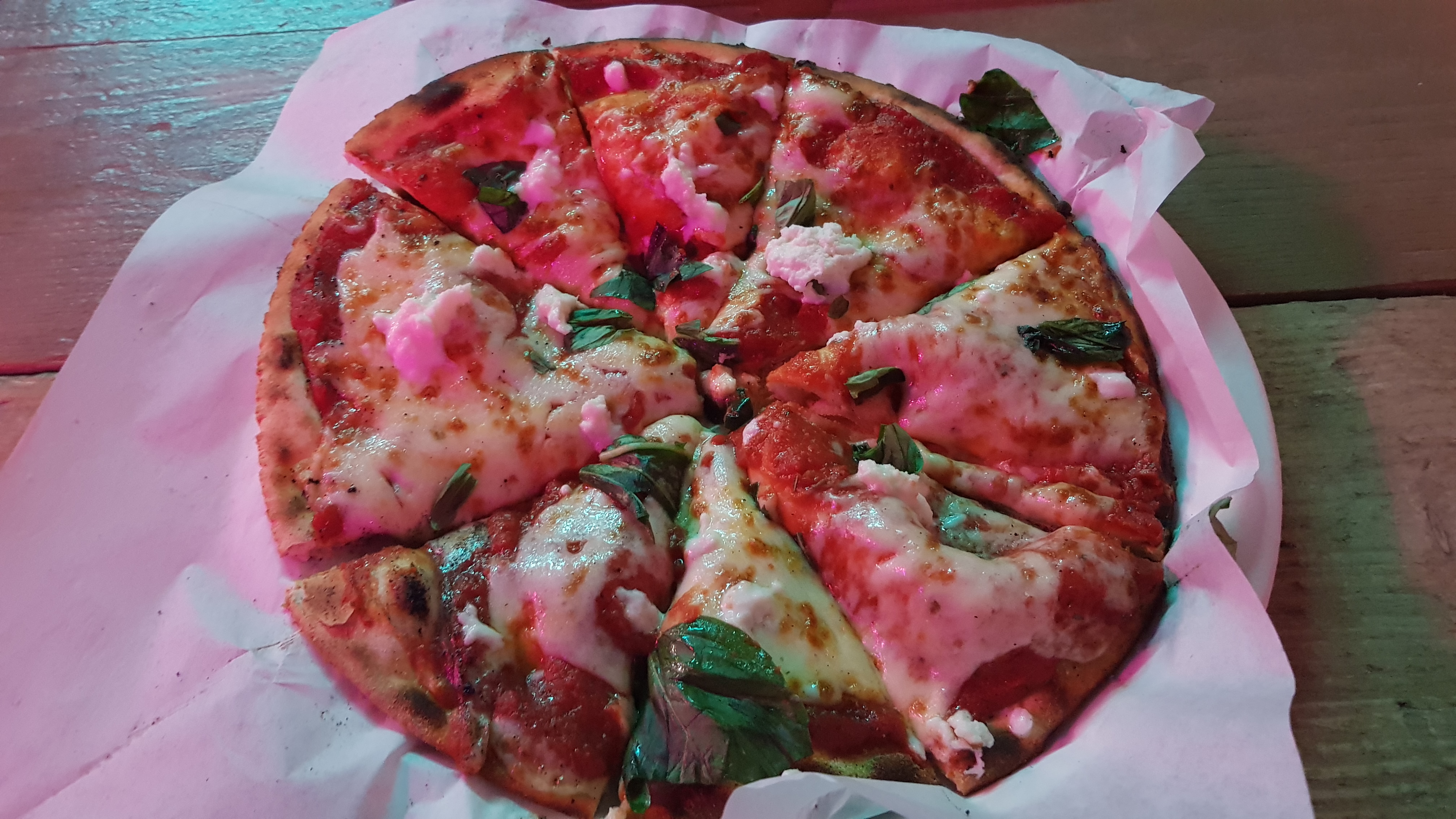 A margherita pizza with tomato sauce, cheese and herbs