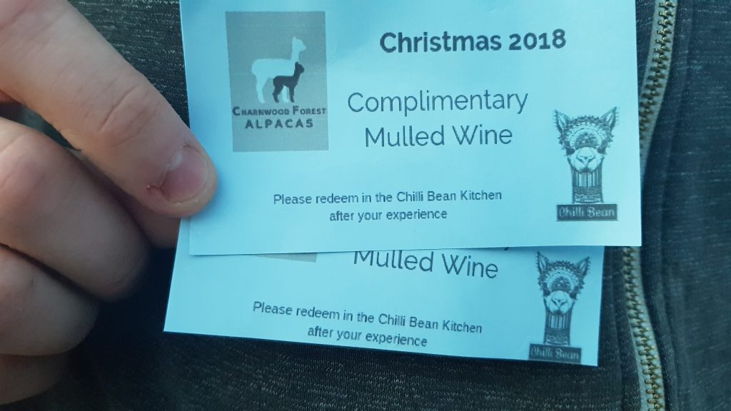 Tickets for Complimentary Mulled Wine at the Chilli Bean Cafe printed on blue card with a cartoon alpaca