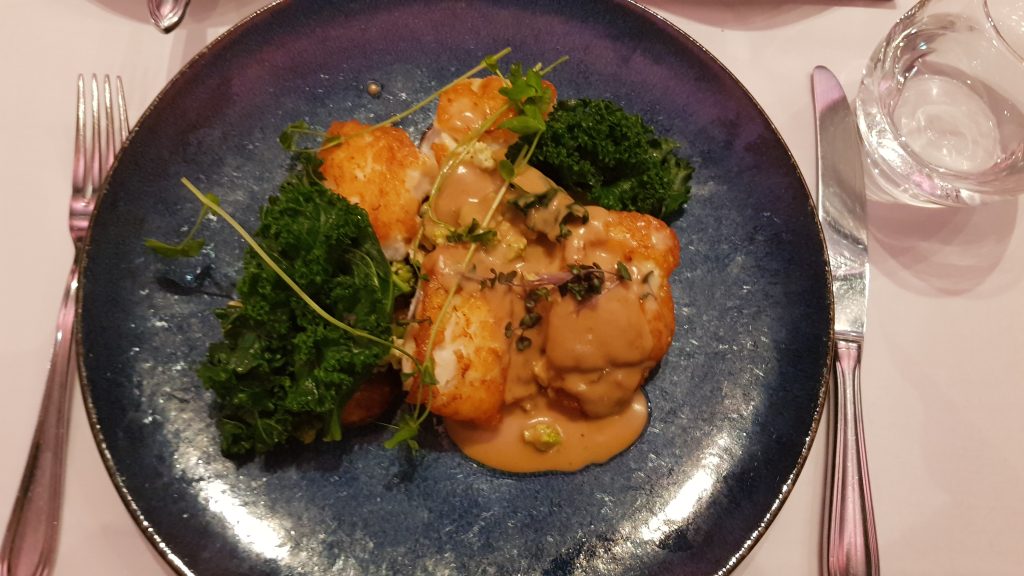 Fish of the day dish at the Lava restaurant in the Blue Lagoon. A fillet of fish in an orange coloured sauce with green vegatables