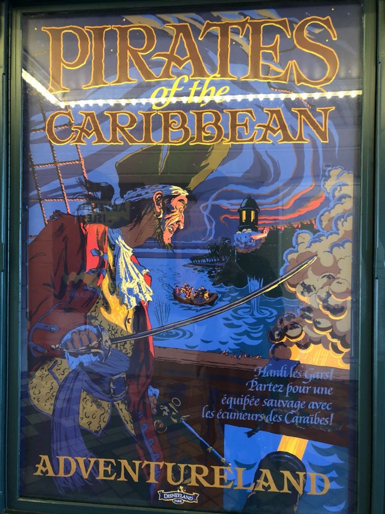 Vintage poster of the Pirates of the Caribbean ride showing a pirate above water where a small boat is moving towards land. At the bottom it says Adventureland