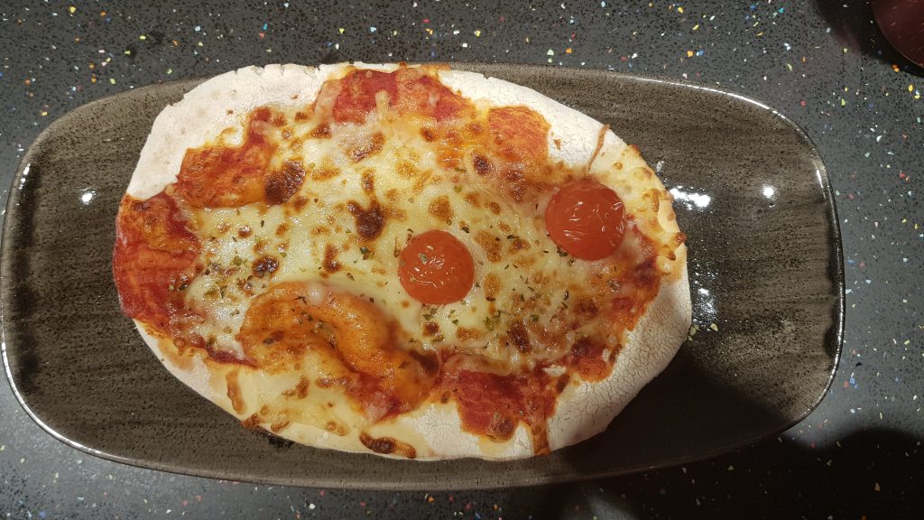 a cheese and tomato pizza on a brown plate served at The Mez in the world's largest Primark, Birmingham
