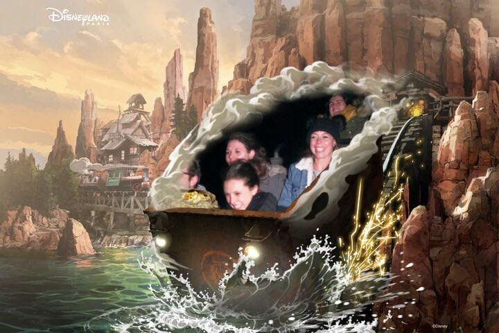 A ride photo from on the Big Thunder Mountain ride at Disneyland Paris. Two girls are in a mine cart styled rollar coaster cart