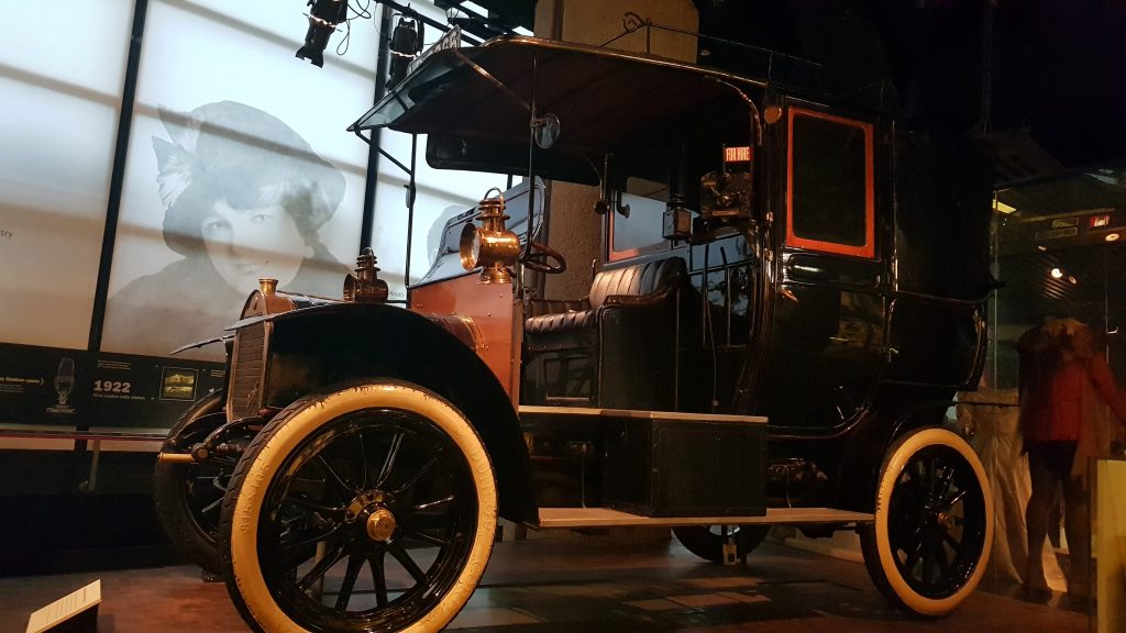 Black open sided car with white tires in the Museum of London