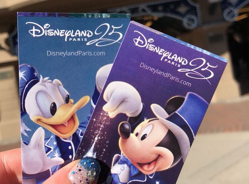25th Anniversary Disneyland Paris park tickets. Two tickets, one blue with Donald Duck on it and one purple with Mickey Mouse on it. Both tickets say Disneyland 25