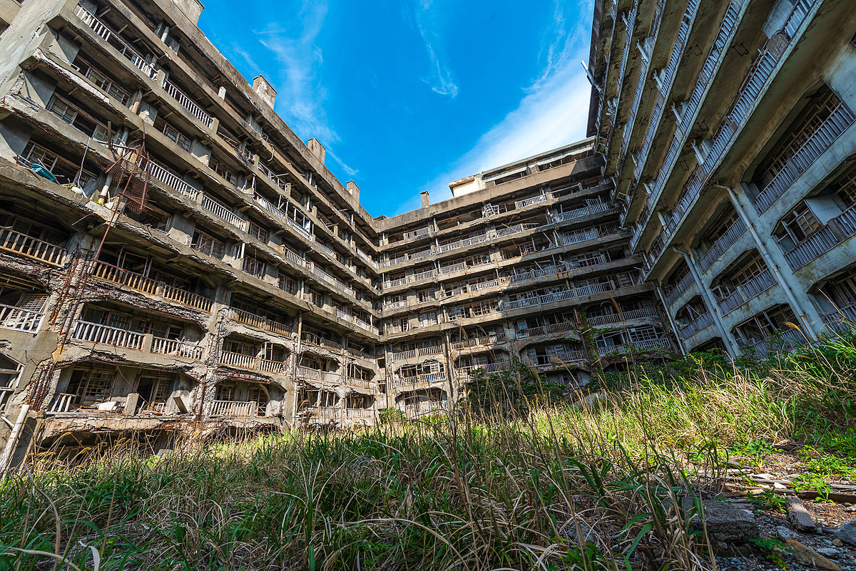 Abandoned buildings surrounded by grass