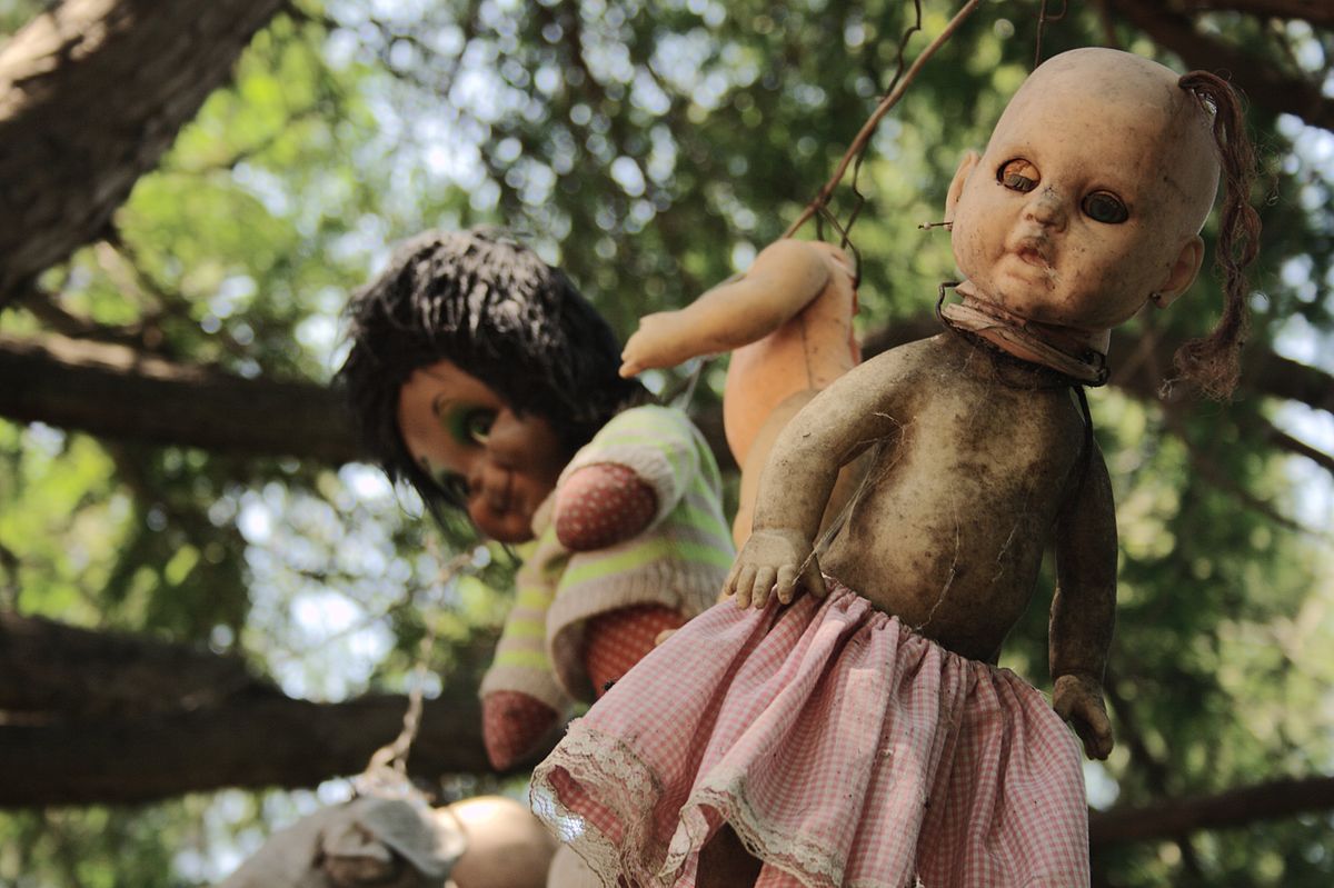 Dirty dolls hanging from trees