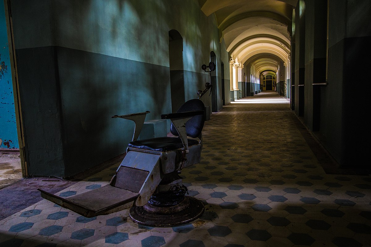 An abandoned operating chair in the middle of a corridor