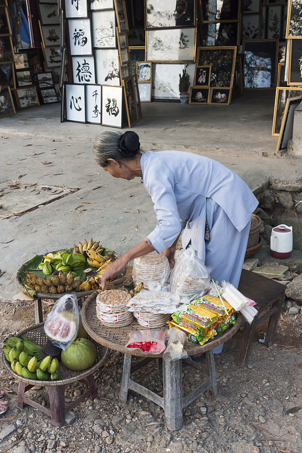 Countries in need: A Vietnamese woman setting up a food stall
